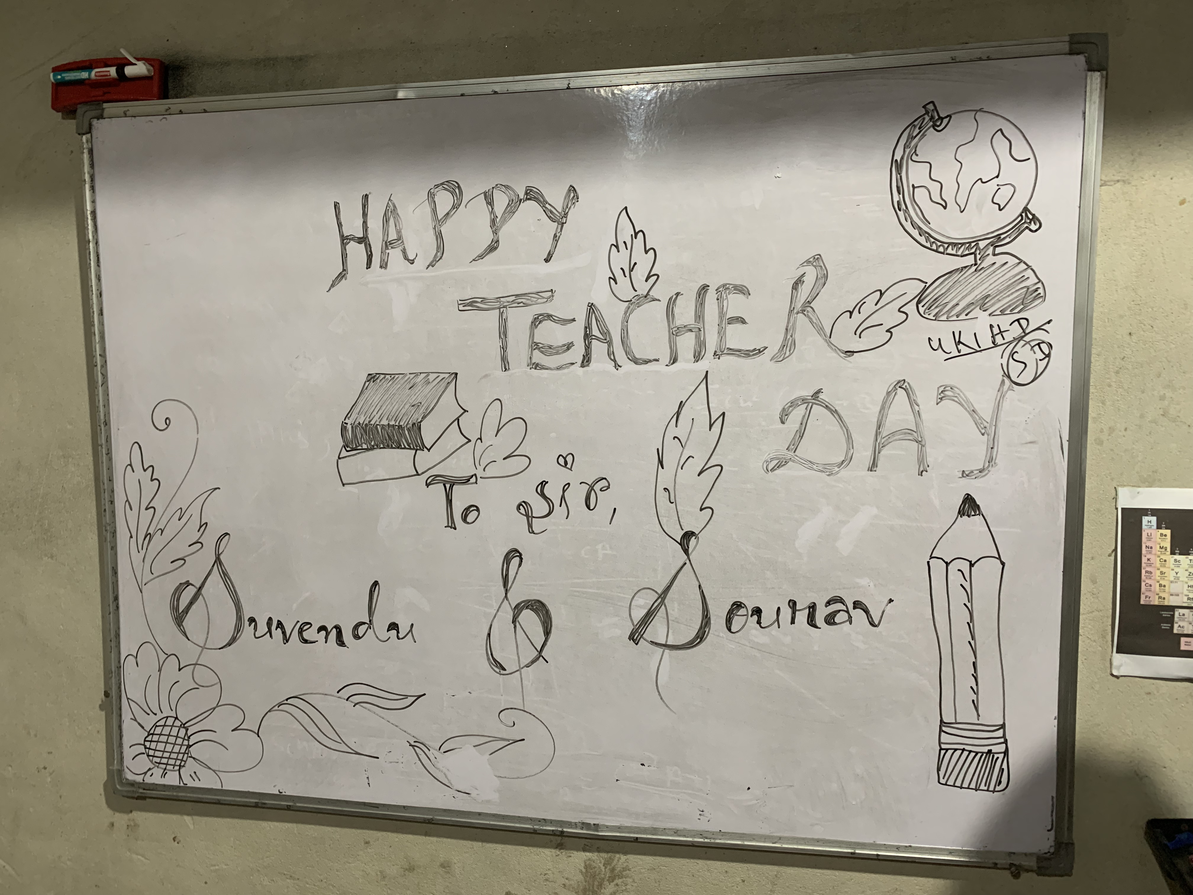 Hand-drawn Happy Teachers Day message on the classroom whiteboard